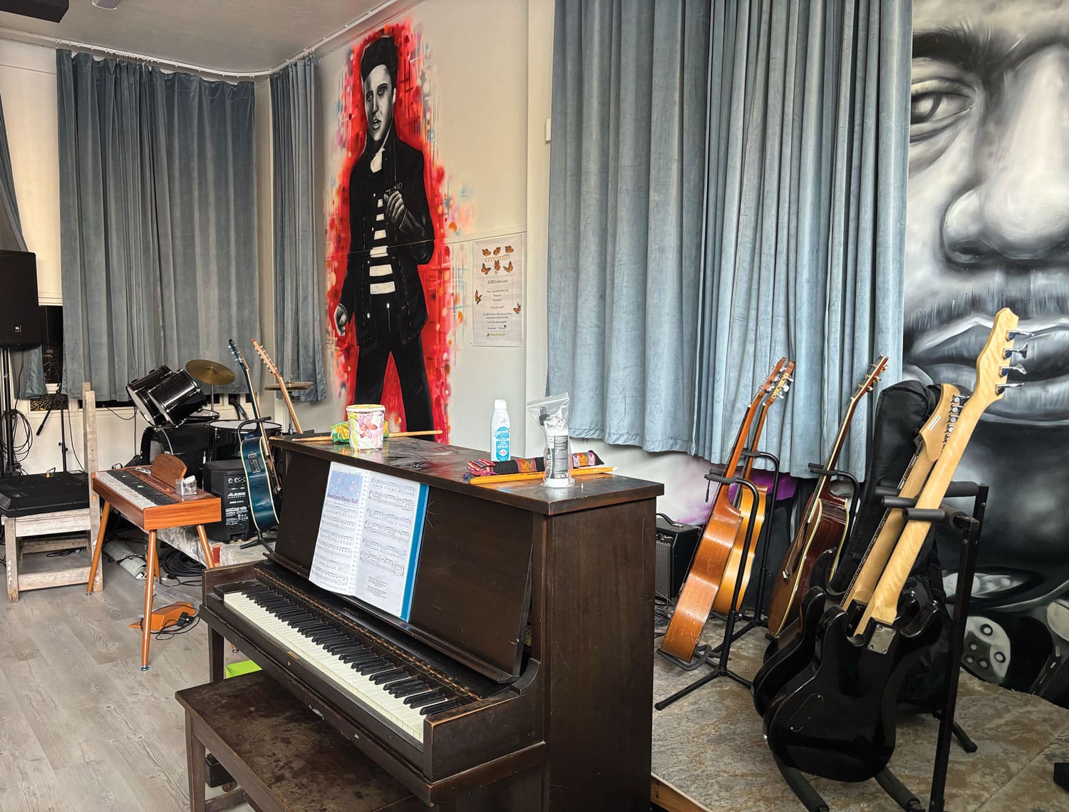 Music room with instruments and wall art.