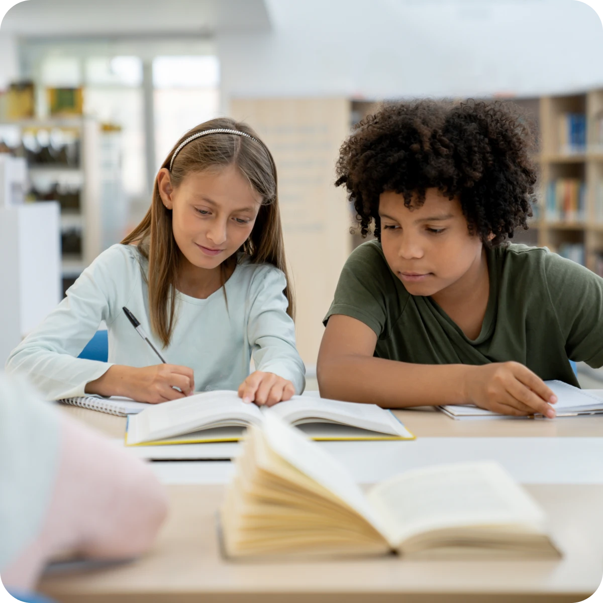 Children studying together in a library.