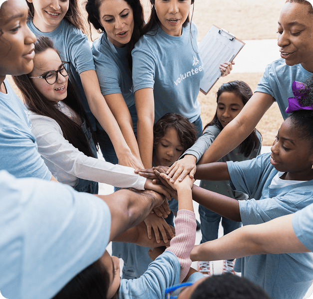 Volunteers huddle in teamwork circle