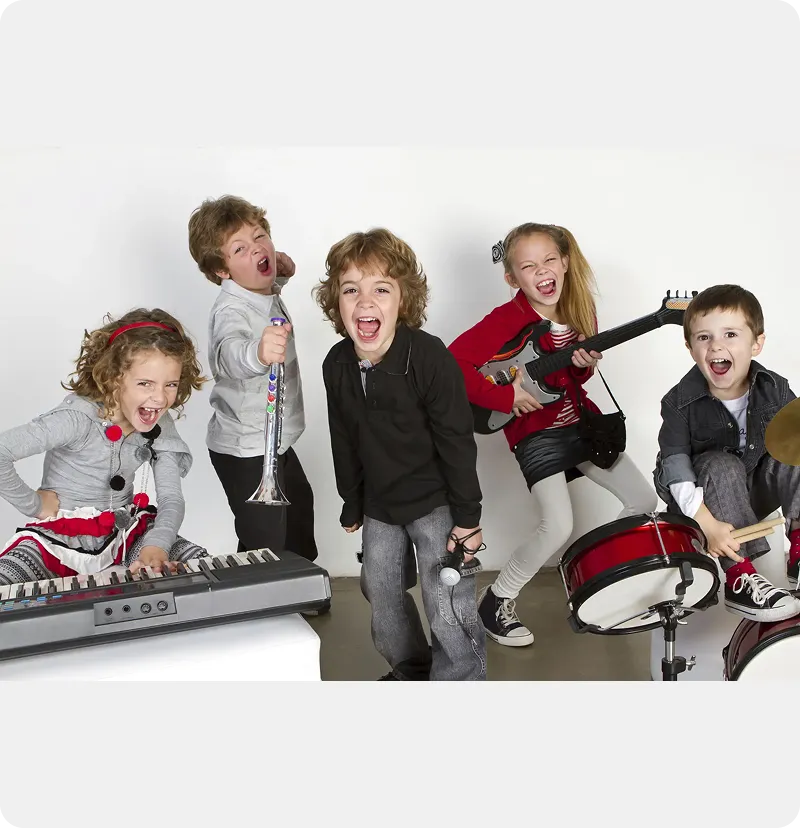 Children playing musical instruments enthusiastically together.