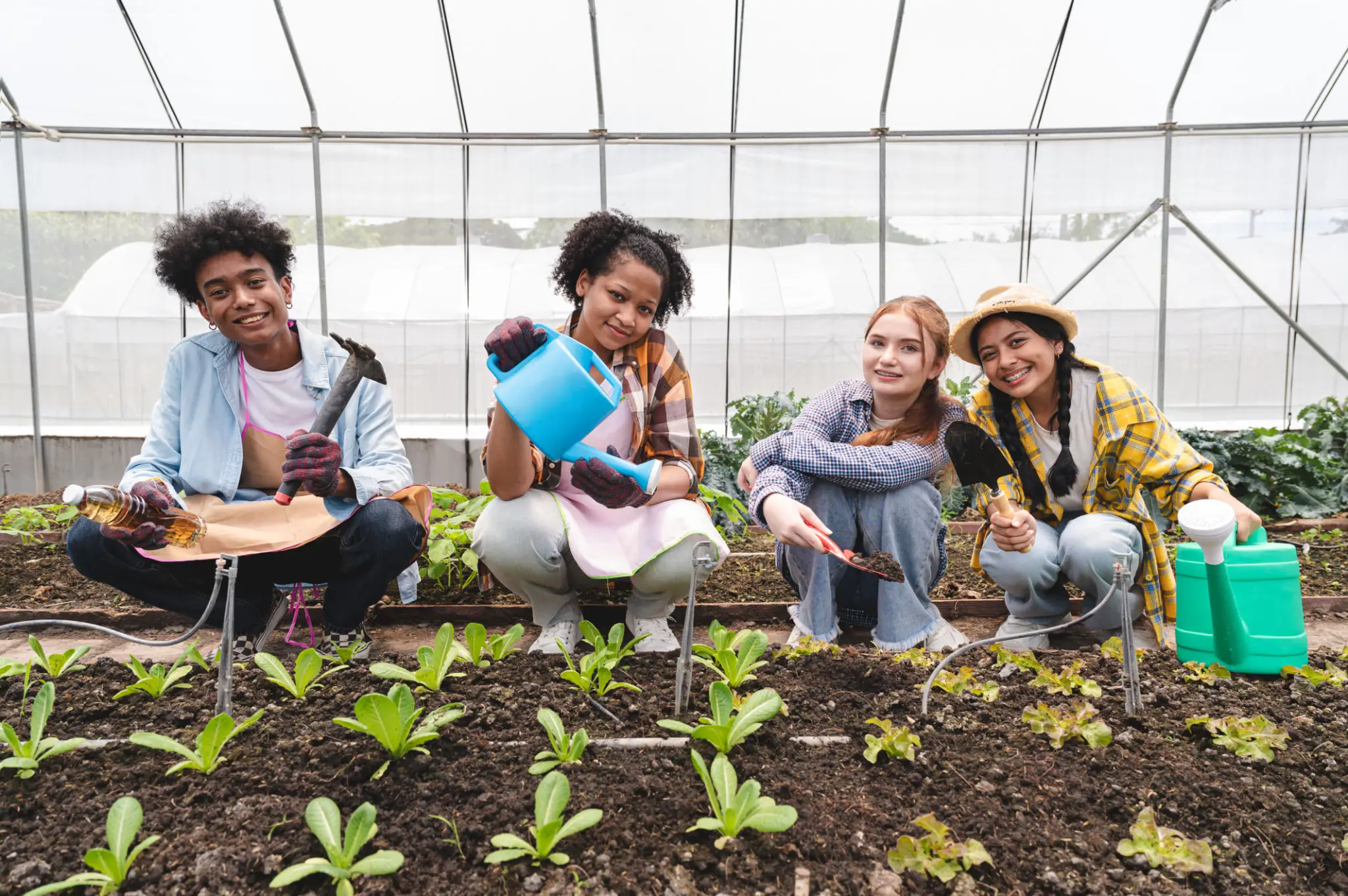 People gardening in a greenhouse together.