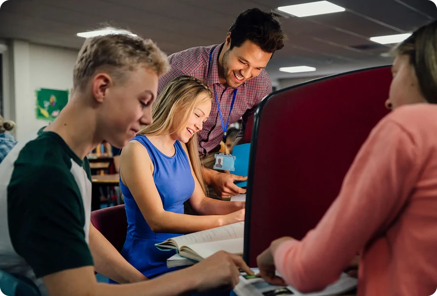 Students studying together with a teacher's guidance.